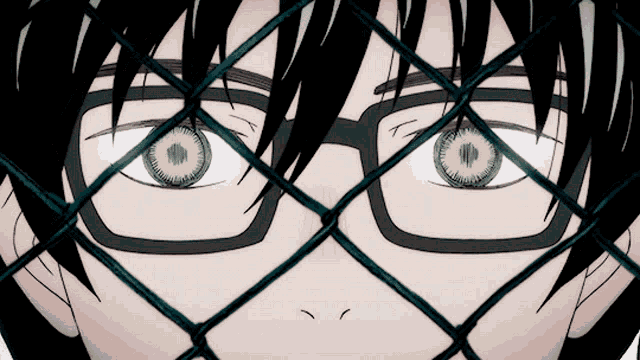 a close up of a person 's face with glasses and green eyes