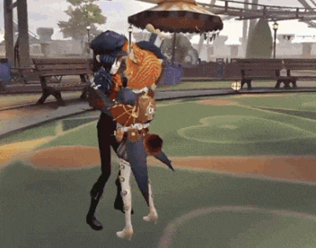 a man in a top hat is holding a woman in his arms in a park .