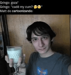 a man is holding a glass of milk in his hands .
