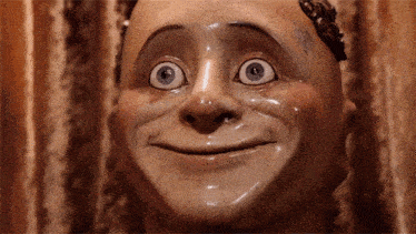 a close up of a statue of a man with big eyes and a cracked face