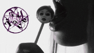 a woman holds a lollipop in her mouth with a pentagram behind her