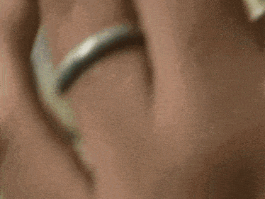 a close up of a woman 's face with a tear on her forehead