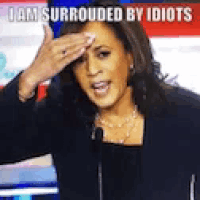 a woman covering her forehead with her hand while speaking into a microphone
