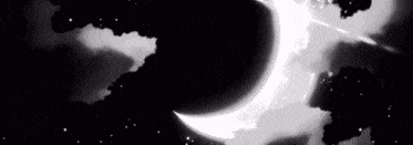 a black and white photo of a crescent moon in a cloudy night sky