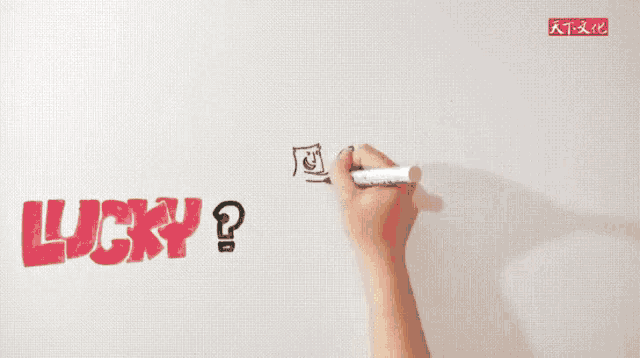 a person is writing the word lucky on a white surface