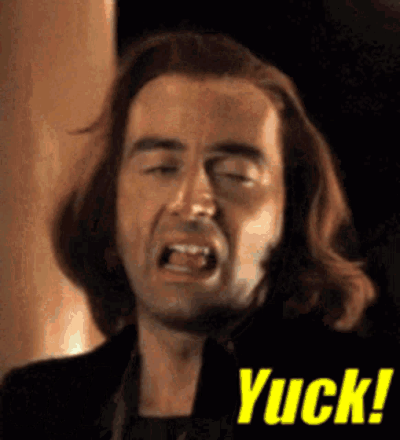 a close up of a man 's face with the word yuck on the bottom right