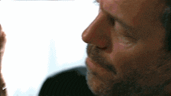a close up of a man 's face with his eyes closed and a beard