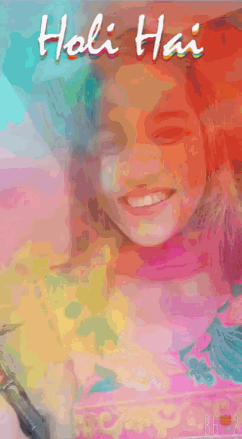 a girl with holi paint on her face is smiling for the camera
