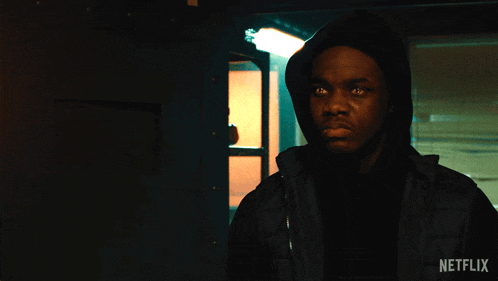 a man in a hooded jacket with a netflix logo