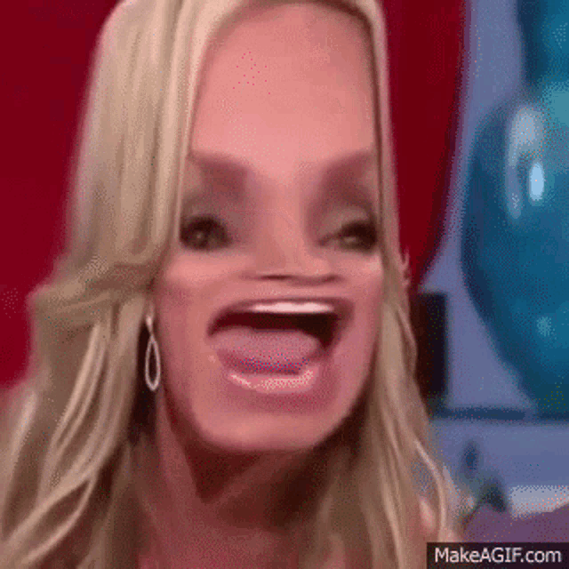 a close up of a woman making a funny face with her tongue out .