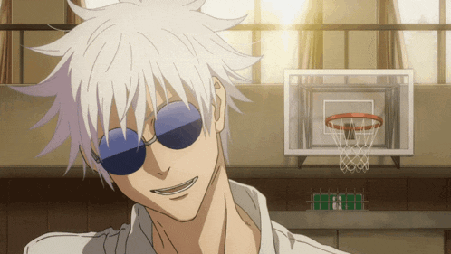 a man wearing sunglasses stands in front of a basketball net