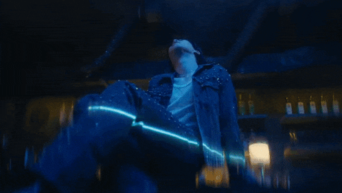 a close up of a person 's face with a blue light shining on it