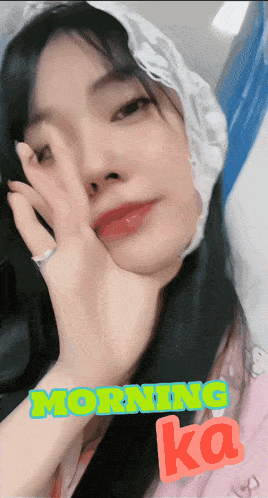 a woman covering her face with her hand with the words morning ka written below her
