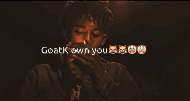 a man is smoking a cigarette with the words goatk own you behind him