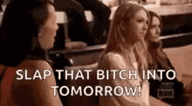 a group of women are sitting in a row and one of them is screaming .