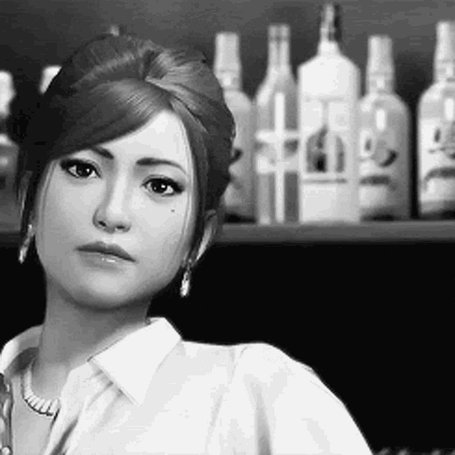 a black and white photo of a woman standing in front of a shelf of bottles .