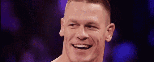 a close up of a man 's face with a purple background smiling .
