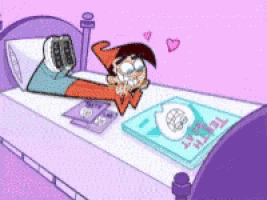 a cartoon character is laying on a bed next to a book that says ' t.m.t. ' on it