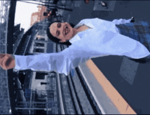 a woman in a white shirt is standing with her arms outstretched and smiling