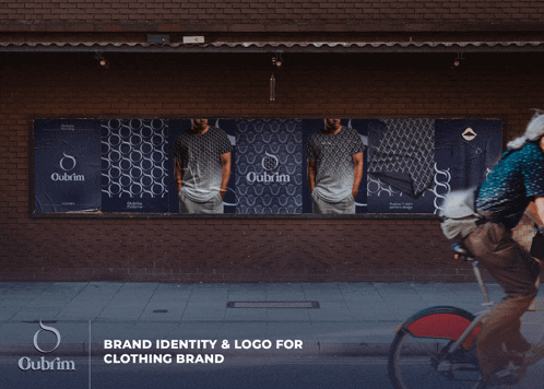 a man riding a bike in front of a billboard that says oubrim