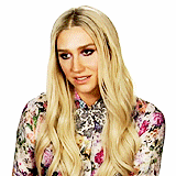 the woman is wearing a floral shirt and a bow tie .