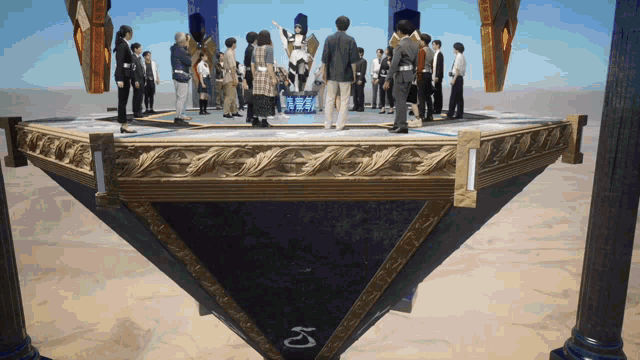 a group of people standing on top of a pyramid with the letter k on the bottom