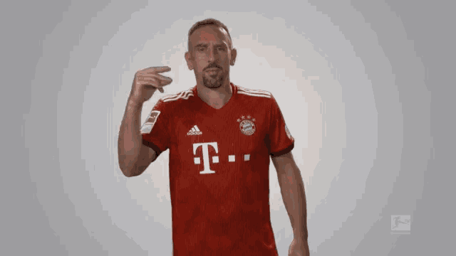 a man wearing a red t-mobile jersey makes a gesture