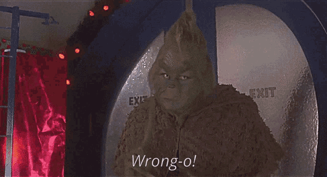 a grinch is standing in front of a sign that says exit