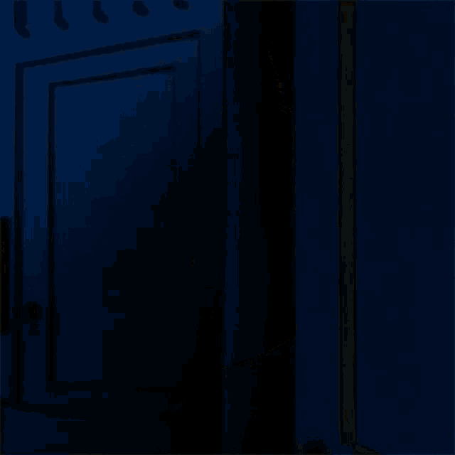 a cartoon character is peeking out from behind a door with his mouth open .