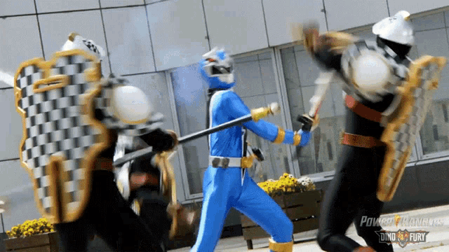 three power rangers are fighting with shields and swords and the words power rangers dino fury are on the bottom