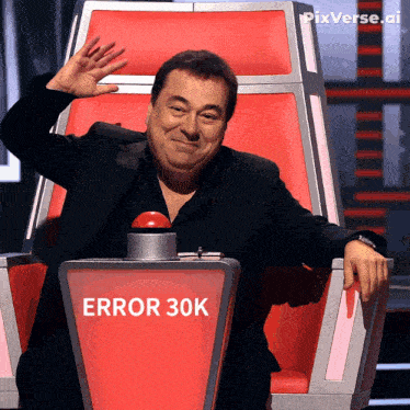 a man sitting in a chair with a red button that says error 30k on it