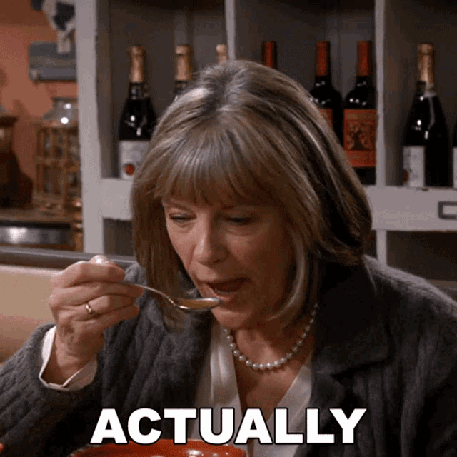 a woman with a spoon in her mouth and the word actually behind her