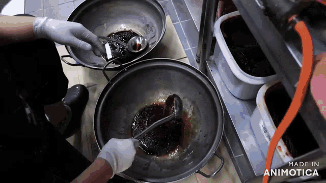 a person is stirring a pot of liquid with a ladle and the words made in animotica are visible