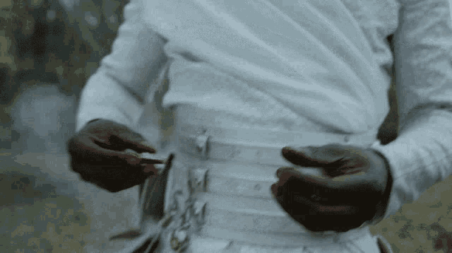 a man wearing a white shirt and a white belt
