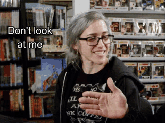 a woman wearing glasses and a black shirt that says " yes no "