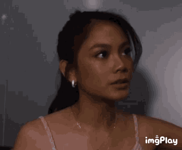 a close up of a woman 's face with the words imgplay on the bottom right