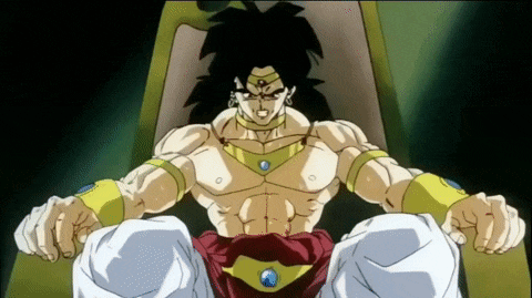 a cartoon character is sitting in a chair with a blue stone on his chest