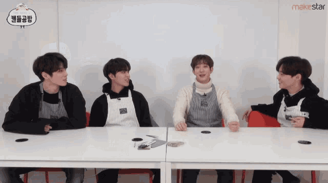 a group of young men are sitting at a table with a makestar logo on the bottom right