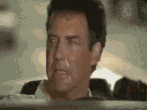 a close up of a man 's face while sitting in a car with his eyes closed .