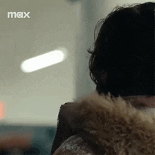 a close up of a person wearing a fur coat and a fur collar .