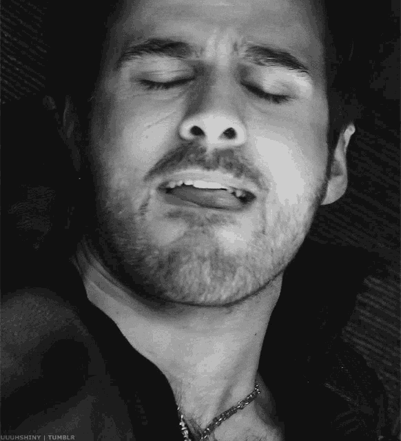 a black and white photo of a man with his eyes closed taken by uughshiny on tumblr