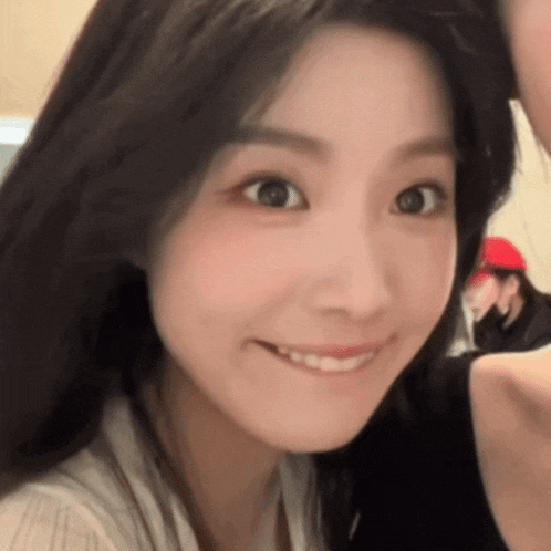 a close up of a woman 's face with a smile