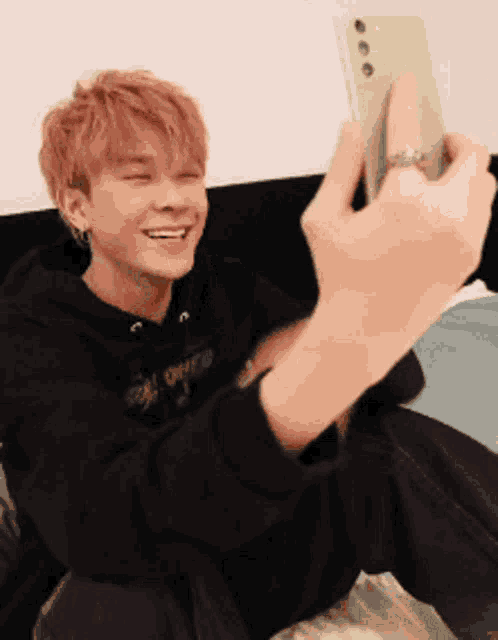a young man is taking a picture of himself with his phone