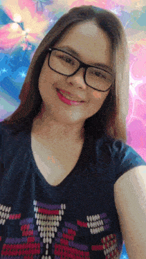 a woman wearing glasses and a black shirt smiles