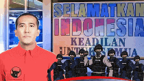 a man in a red shirt stands in front of a sign that says selamatkan indonesia