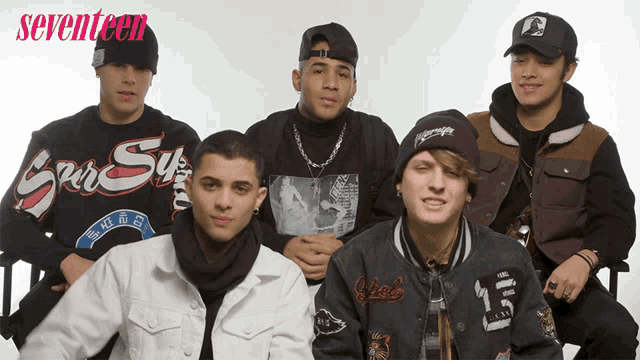 a group of young men are posing for a picture with the words seventeen behind them