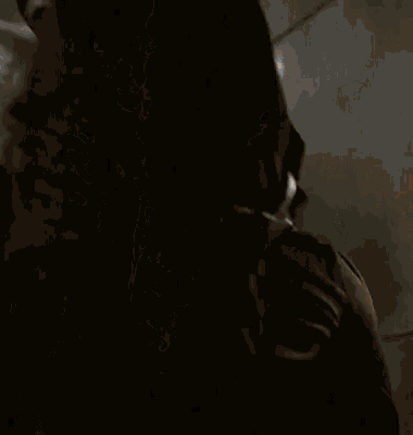 a group of people are standing in a dark room