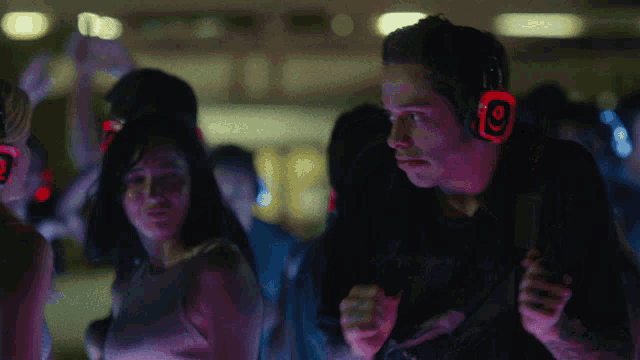 a man wearing red headphones with the number 9 on it