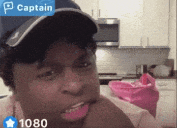 a man wearing a hat with the word captain on the top