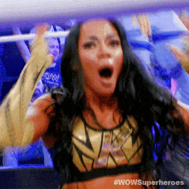 a woman in a wrestling ring with #wowsuperheroes written on the bottom right